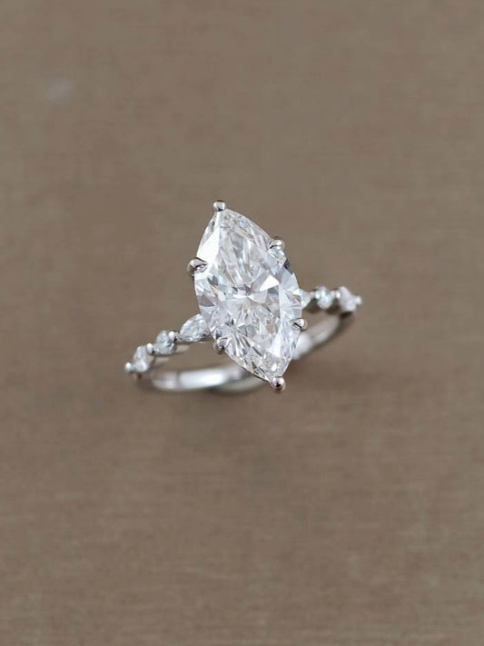 Angled view of Emily Marquise Lab Grown Diamond Half Pavé Solitaire Engagement Ring featuring an IGI Certified Marquise diamond