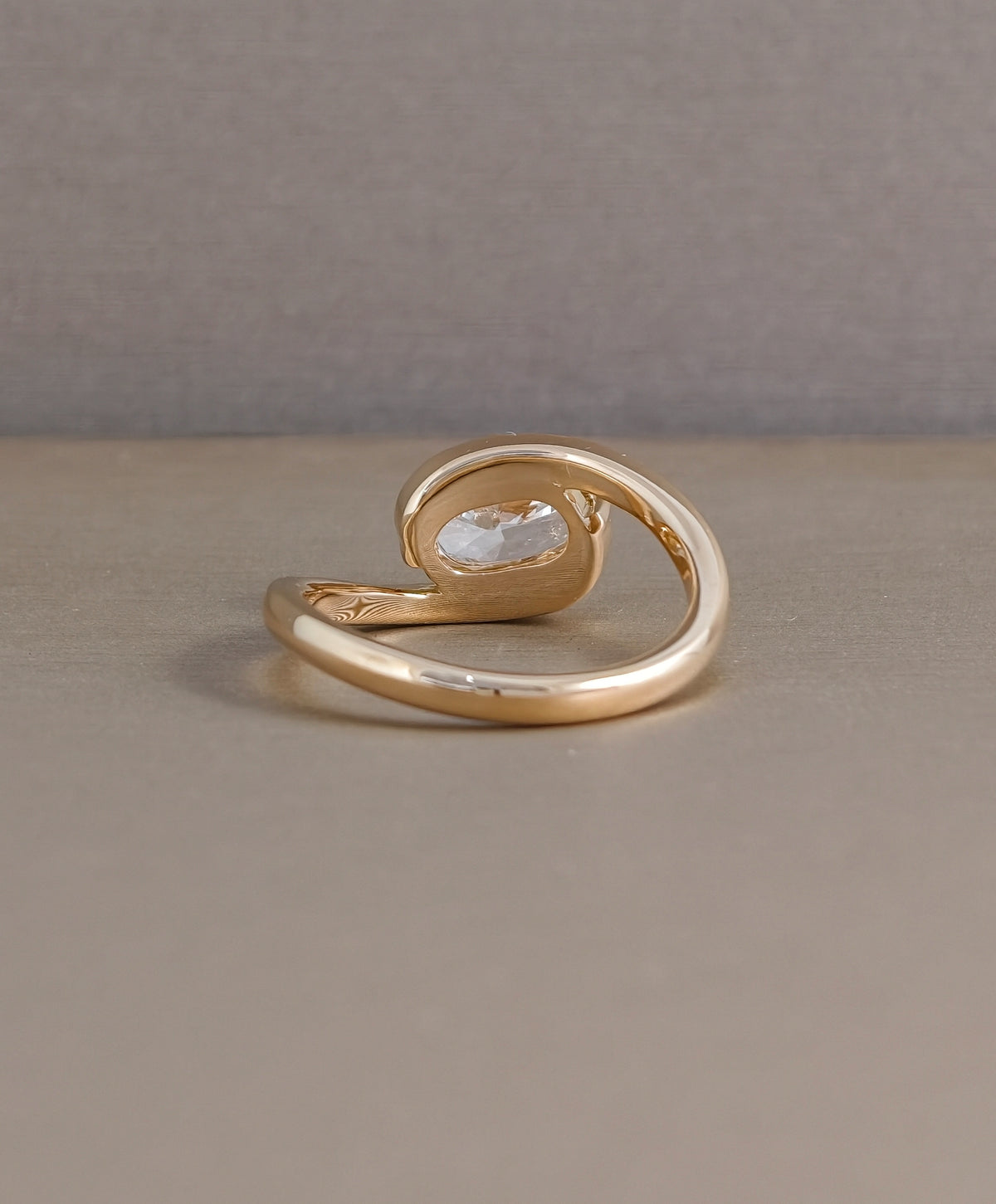 Rear view of yellow gold cushion cut lab grown diamond engagement ring showing twist band construction