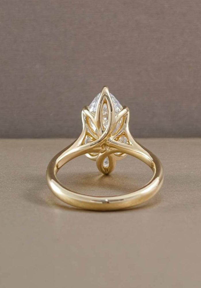 Back view of marquise tulip engagement ring showing sculpted floral gold setting and open gallery