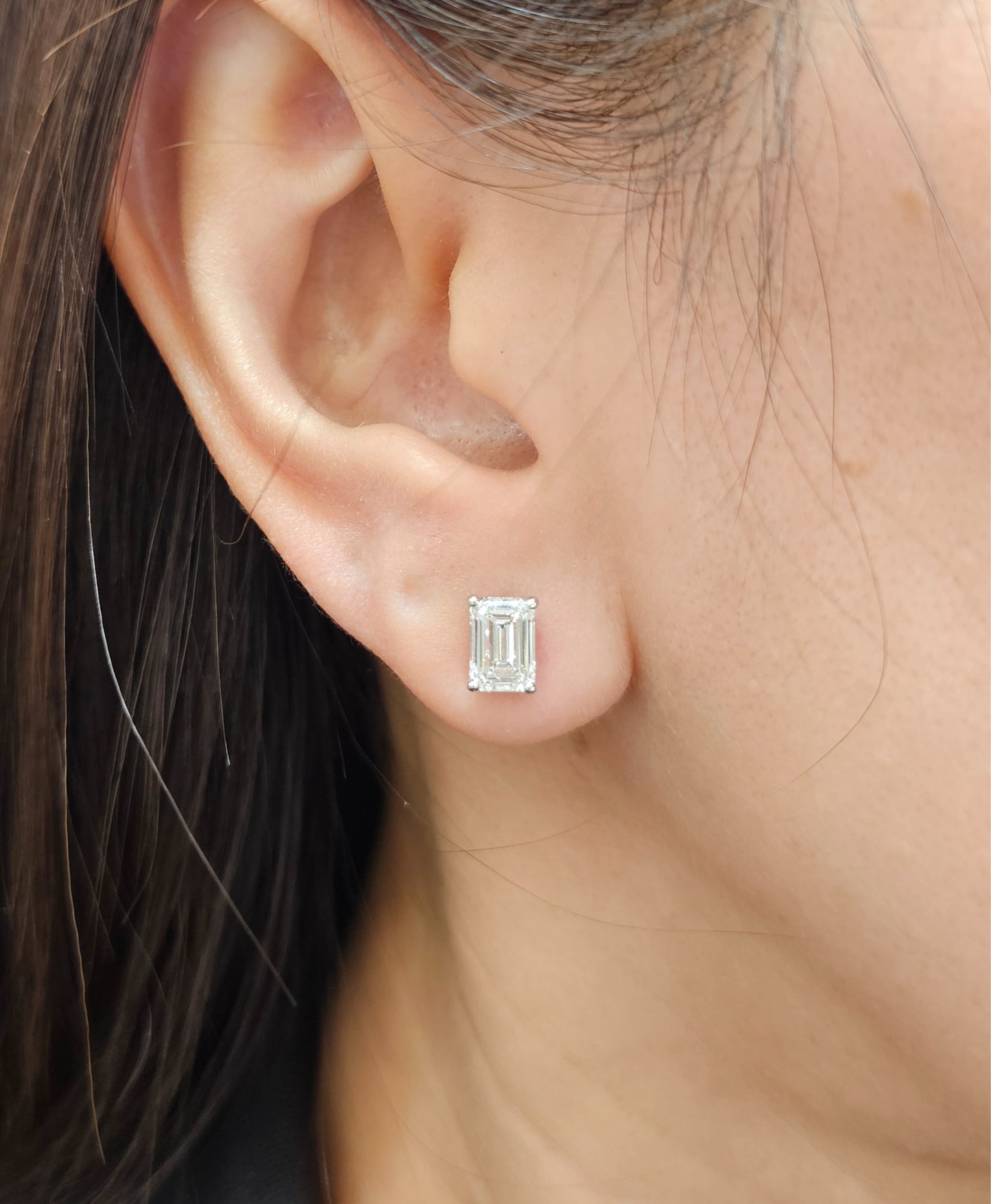 Woman wearing Emerald lab grown diamond stud earrings in Bangkok | Sphere Diamond