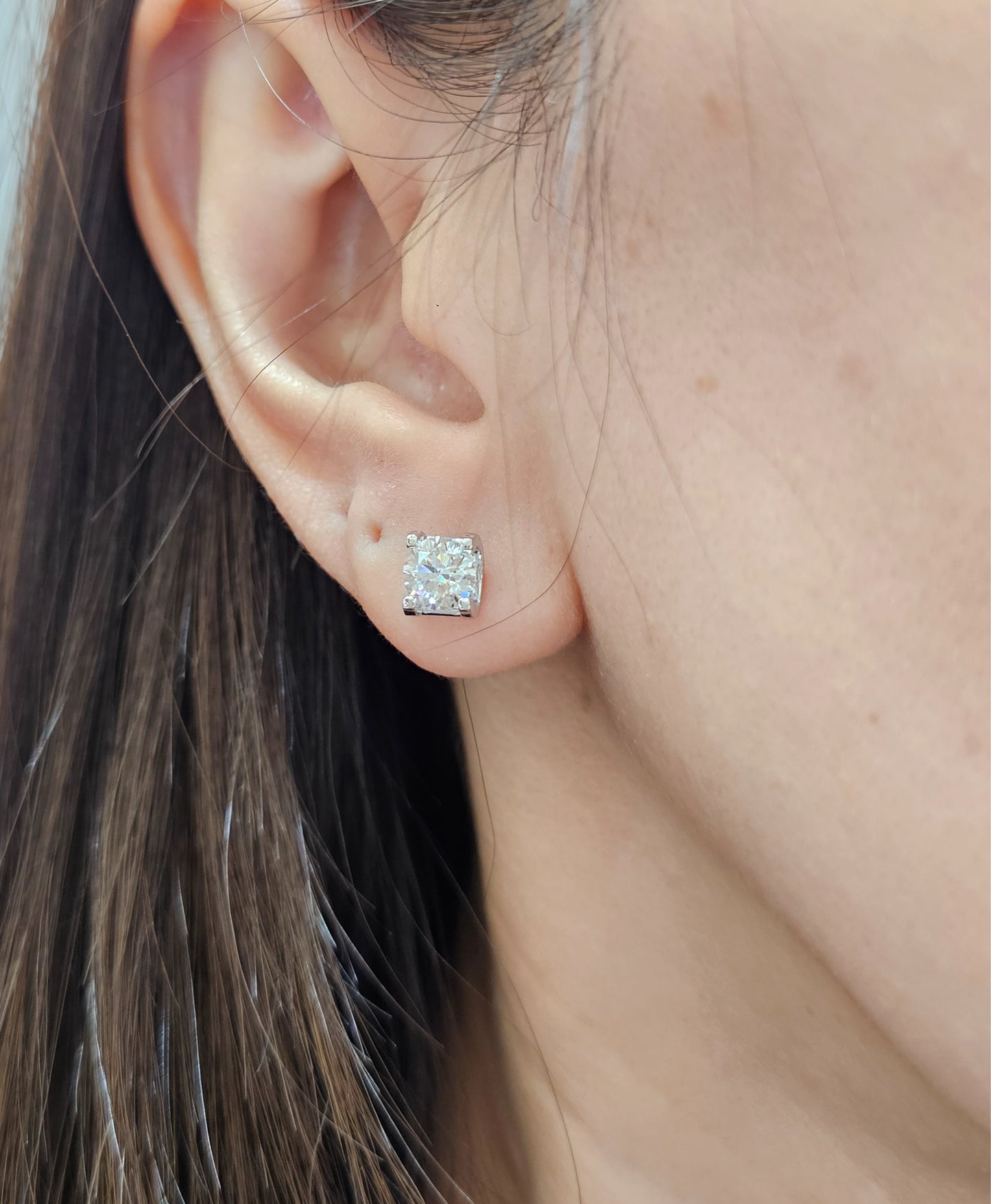 Woman wearing Round Brilliant IGI Certified Lab Grown Diamond Stud Earrings by Sphere Diamond Bangkok