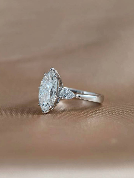 Side angle of Elara Marquise Lab Grown Diamond Three Stone Engagement Ring with round brilliant side diamonds and IGI Certified center diamond
