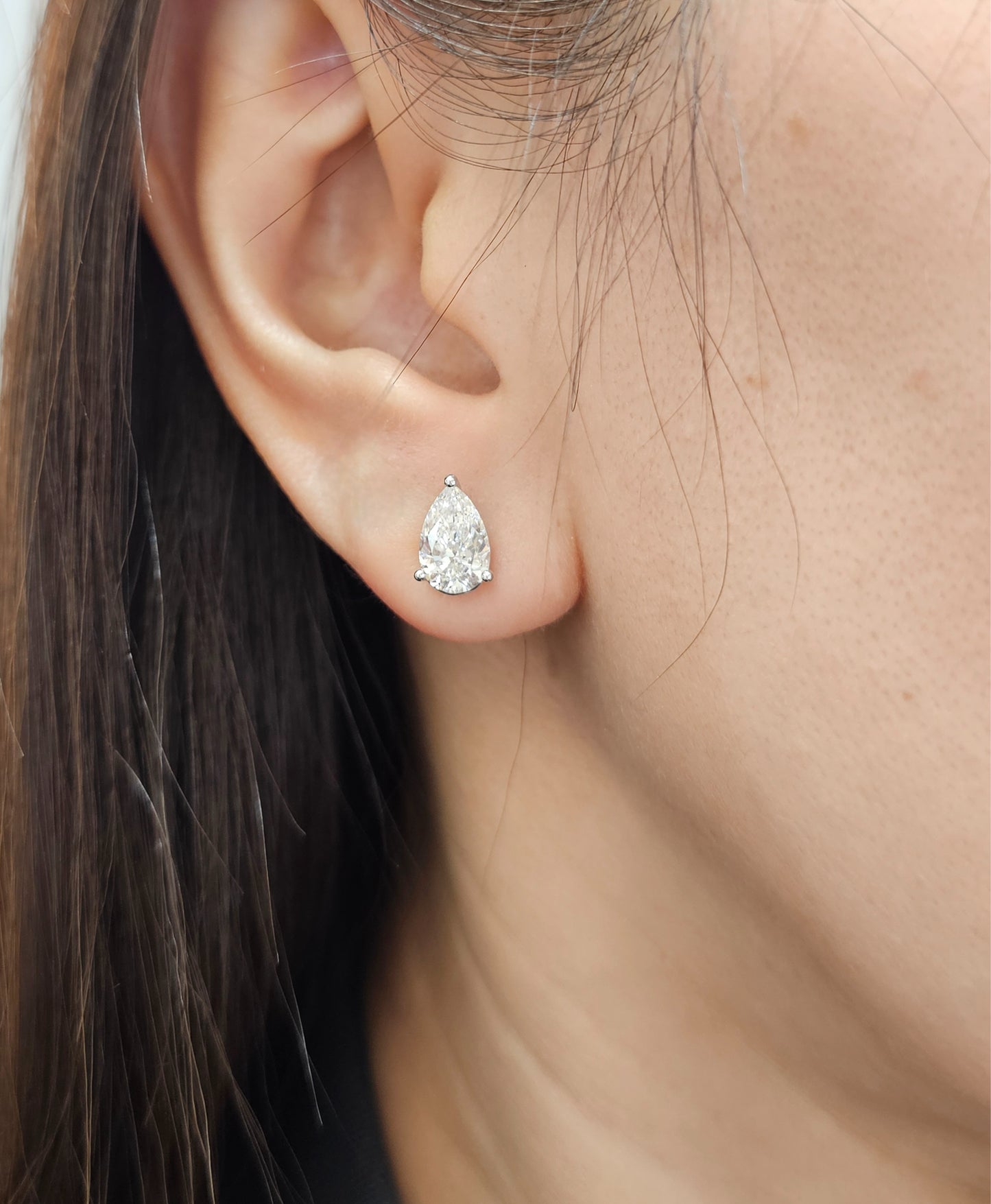 Woman wearing Pear lab grown diamond stud earrings in Bangkok | Sphere Diamond