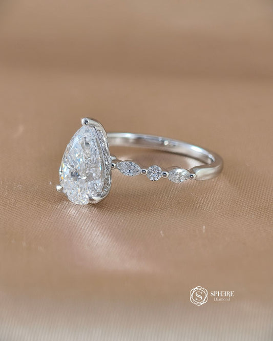 Left angle of Emily pear lab grown diamond engagement ring with marquise and round side stones | IGI Certified | Sphere Diamond Bangkok