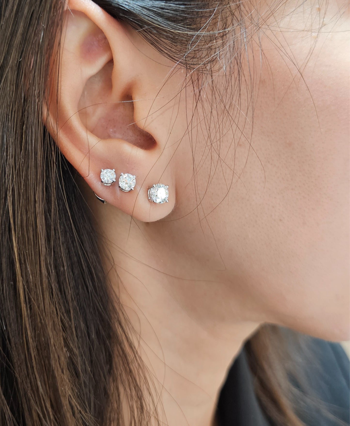 Woman wearing Round lab grown diamond stud earrings in different sizes by Sphere Diamond Bangkok