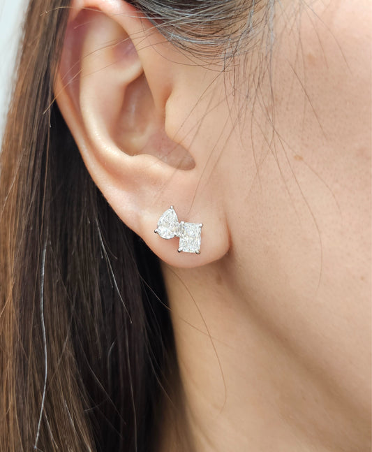 Model wearing Luna Pear and Emerald Toi et Moi lab grown diamond stud earrings by Sphere Diamond Bangkok