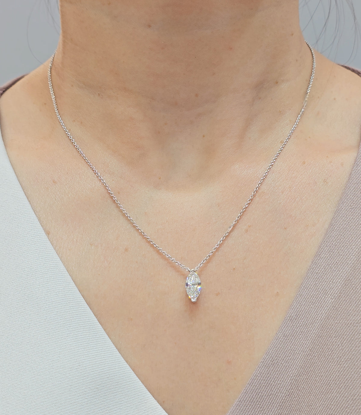 Model wearing marquise cut lab grown diamond floating pendant necklace in white gold by Sphere Diamond Bangkok