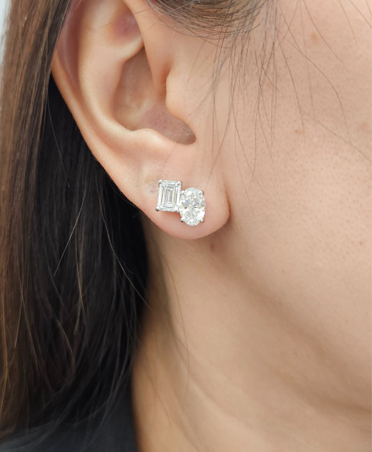 Model wearing Emerald and Oval Toi et Moi lab grown diamond stud earrings by Sphere Diamond Bangkok