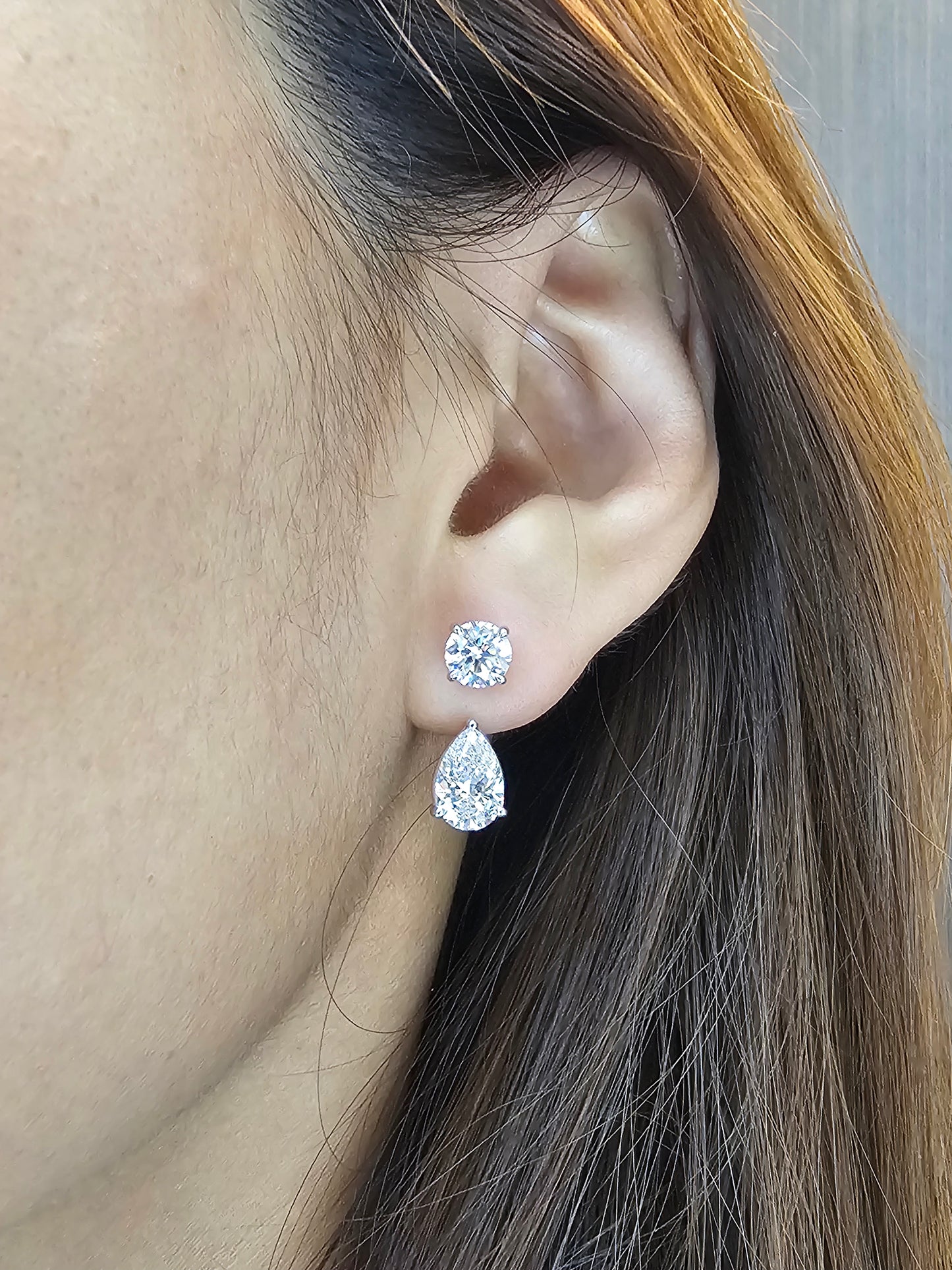 Woman wearing Round and Pear lab grown diamond convertible drop earrings by Sphere Diamond Bangkok