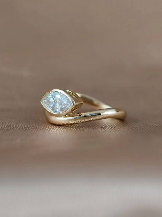 Side view of Signature Luna East-West marquise lab grown diamond bezel engagement ring featuring an IGI certified lab grown diamond by Sphere Diamond Thailand