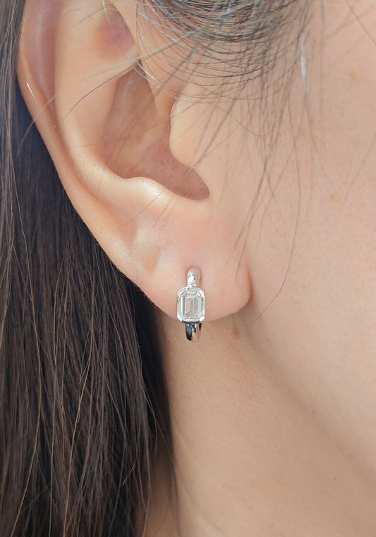 Emerald Cut Lab Grown Diamond Huggie Hoop Earrings in White Gold on ear

