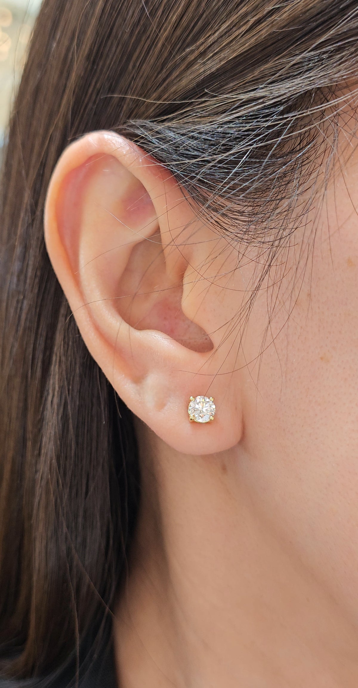 Round Brilliant Lab Grown Diamond Stud Earrings in Yellow Gold on ear