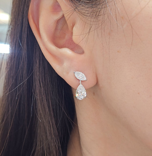 Woman wearing marquise and pear shaped lab grown diamond drop earring, elegant bridal diamond jewelry by Sphere Diamond