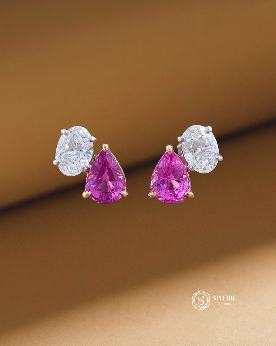 Pink sapphire pear cut and oval lab grown diamond Toi et Moi stud earrings with two-tone prong settings by Sphere Diamond Bangkok