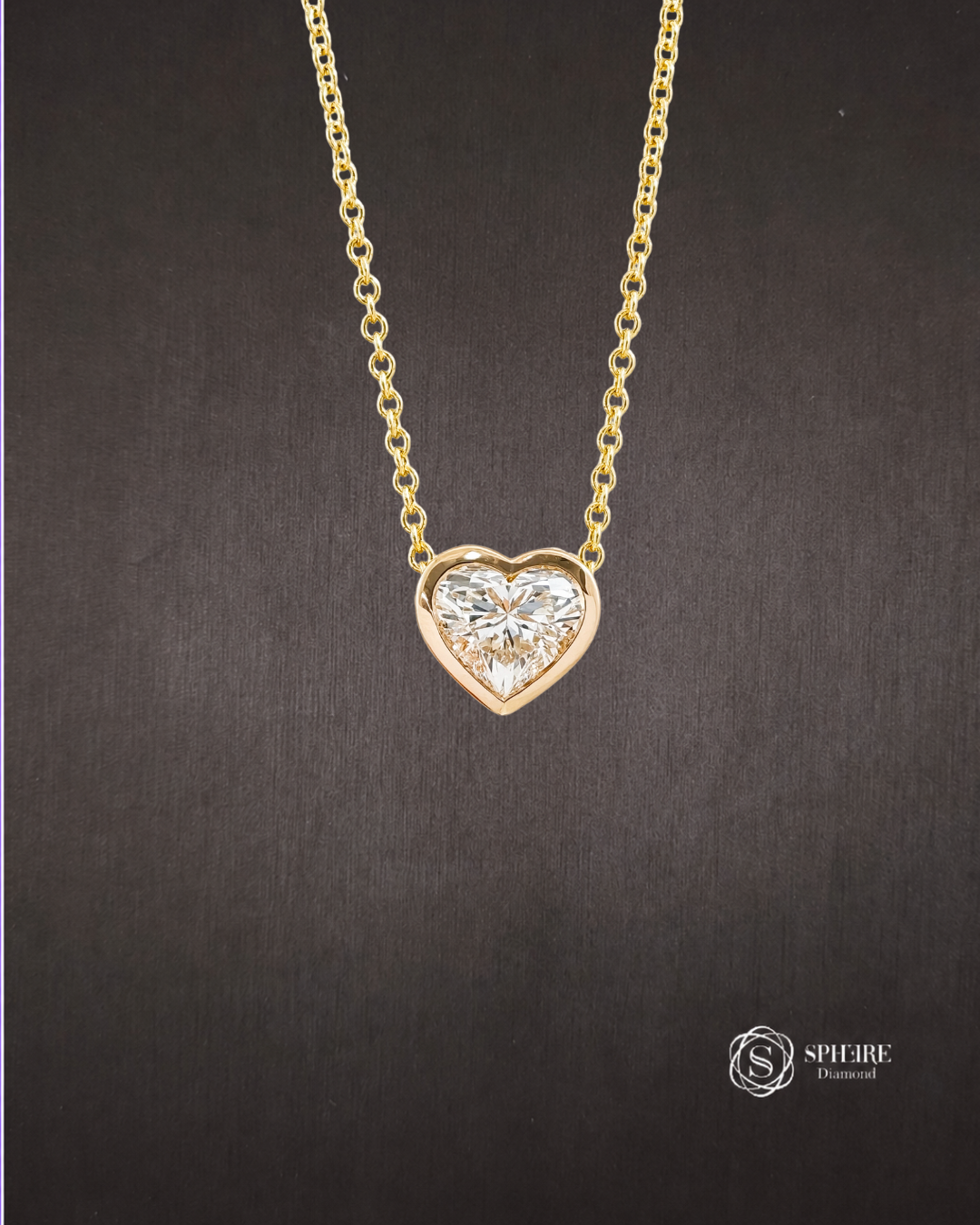 Shop the Amour Heart Cut Lab Grown Diamond Bezel Pendant Necklace in Yellow Gold at Sphere Diamond Bangkok. Custom made lab grown diamond jewelry in Thailand.