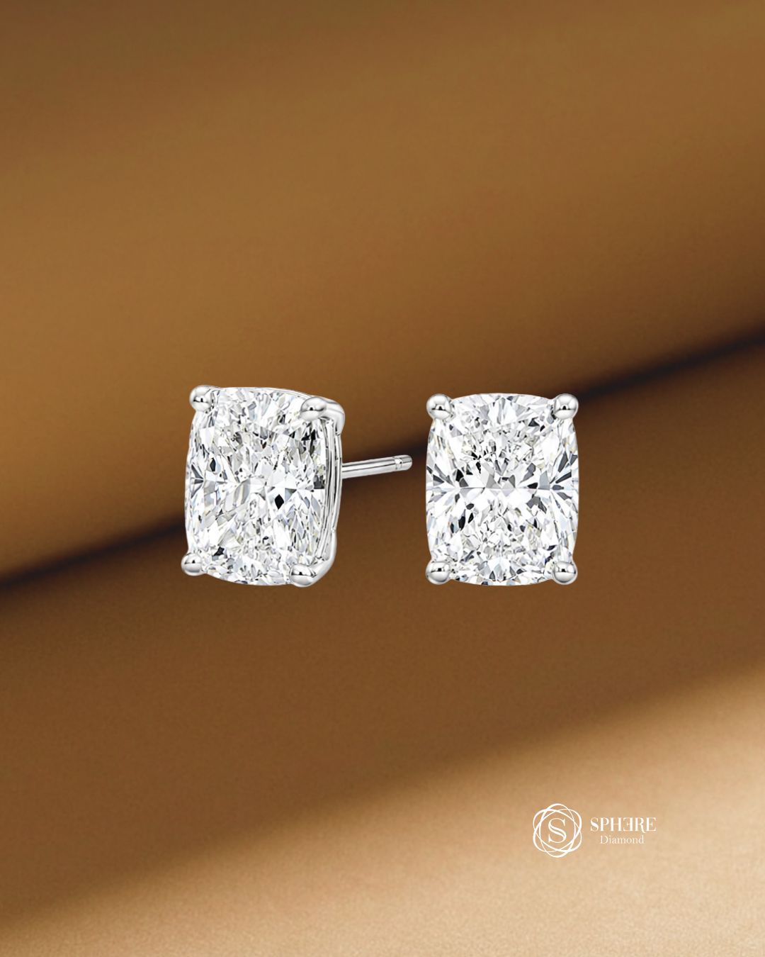 A pair of cushion-cut diamond stud earrings in a white gold setting with IGI certificate, by Sphere diamond Bangkok Thailand