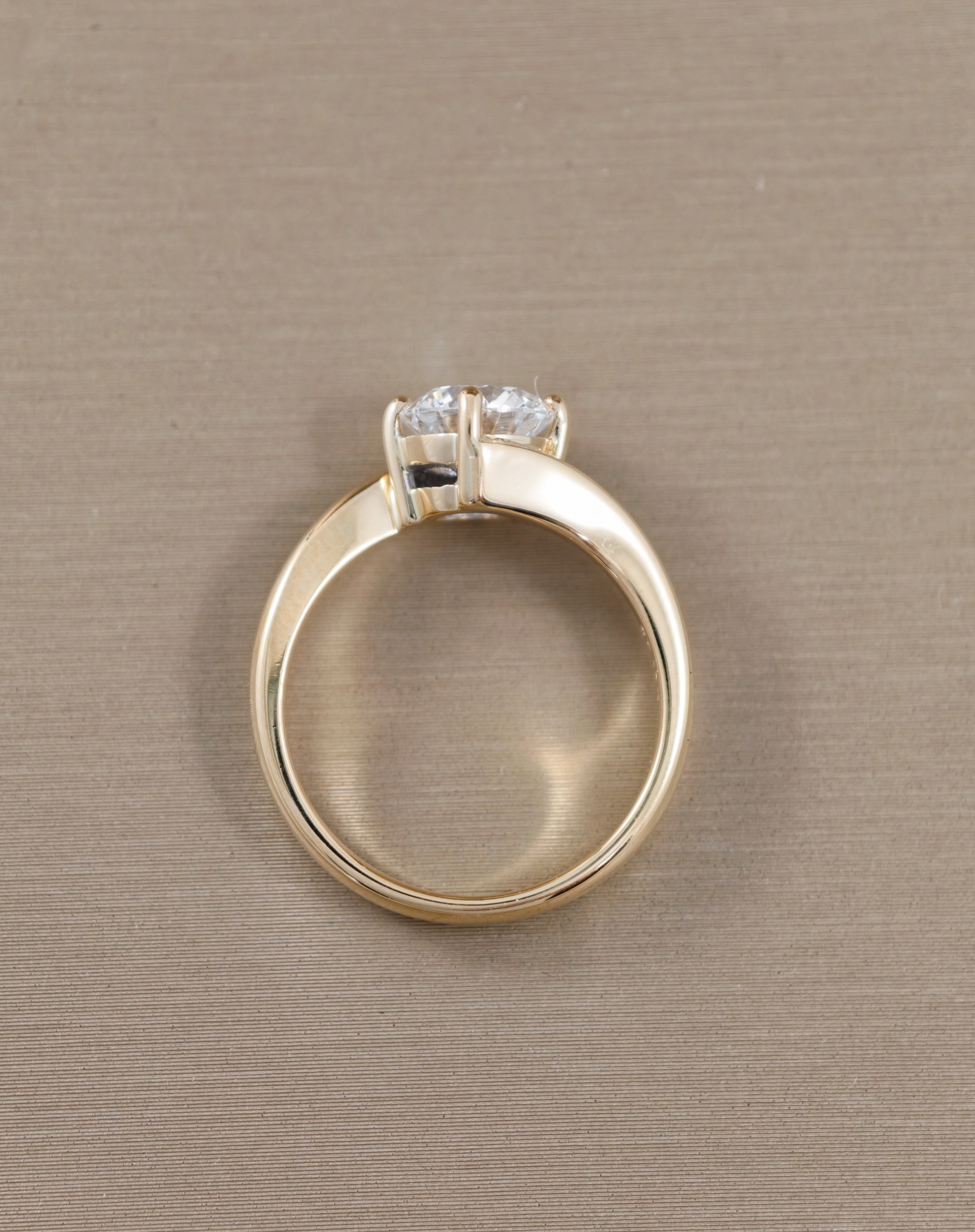A yellow gold ring with a LAB diamond
