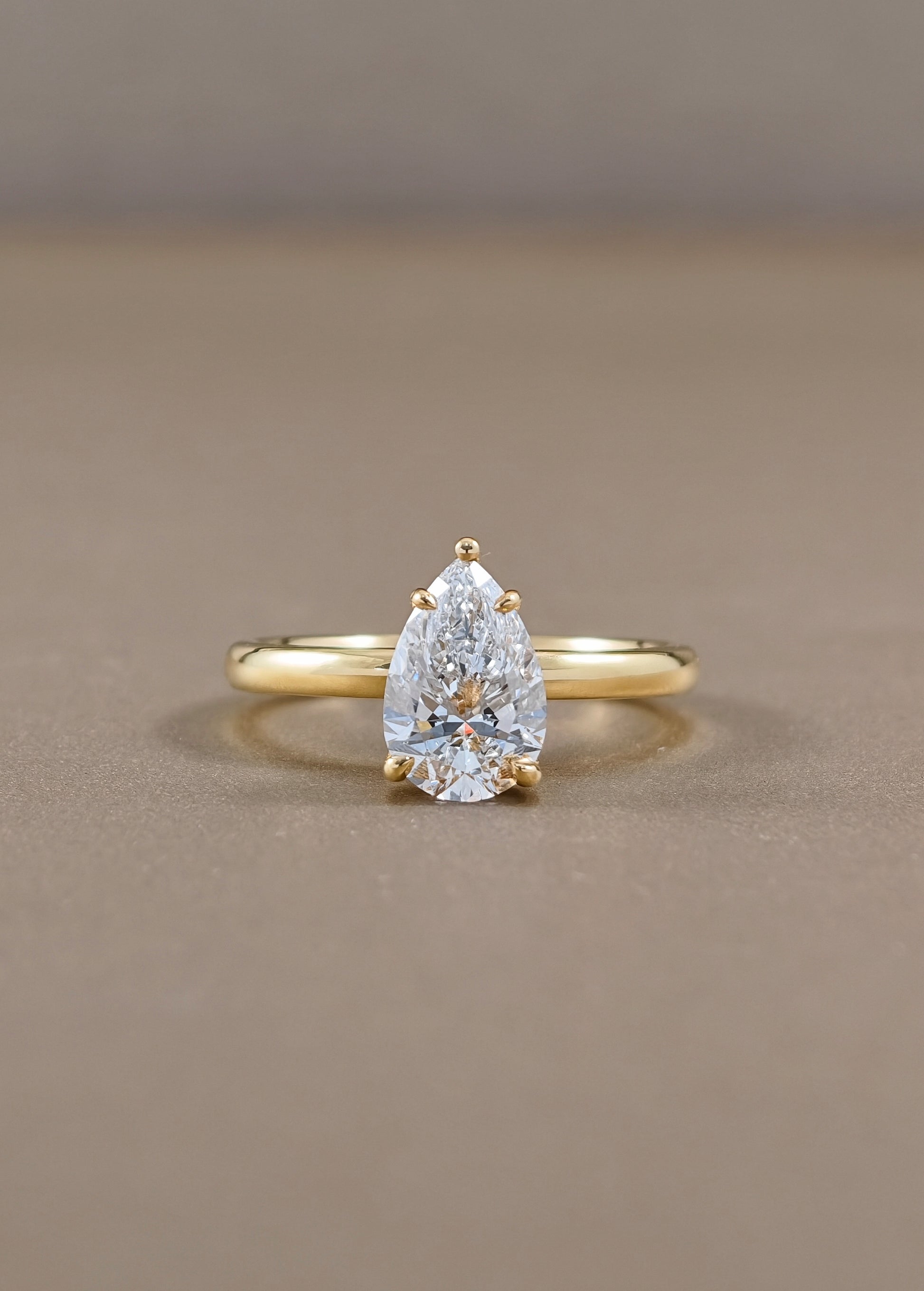 Solène Pear Cut Lab Grown Diamond Solitaire Engagement Ring in Yellow Gold Sphere Diamond Bangkok