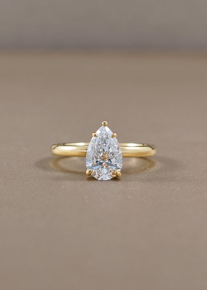 Solène Pear Cut Lab Grown Diamond Solitaire Engagement Ring in Yellow Gold Sphere Diamond Bangkok