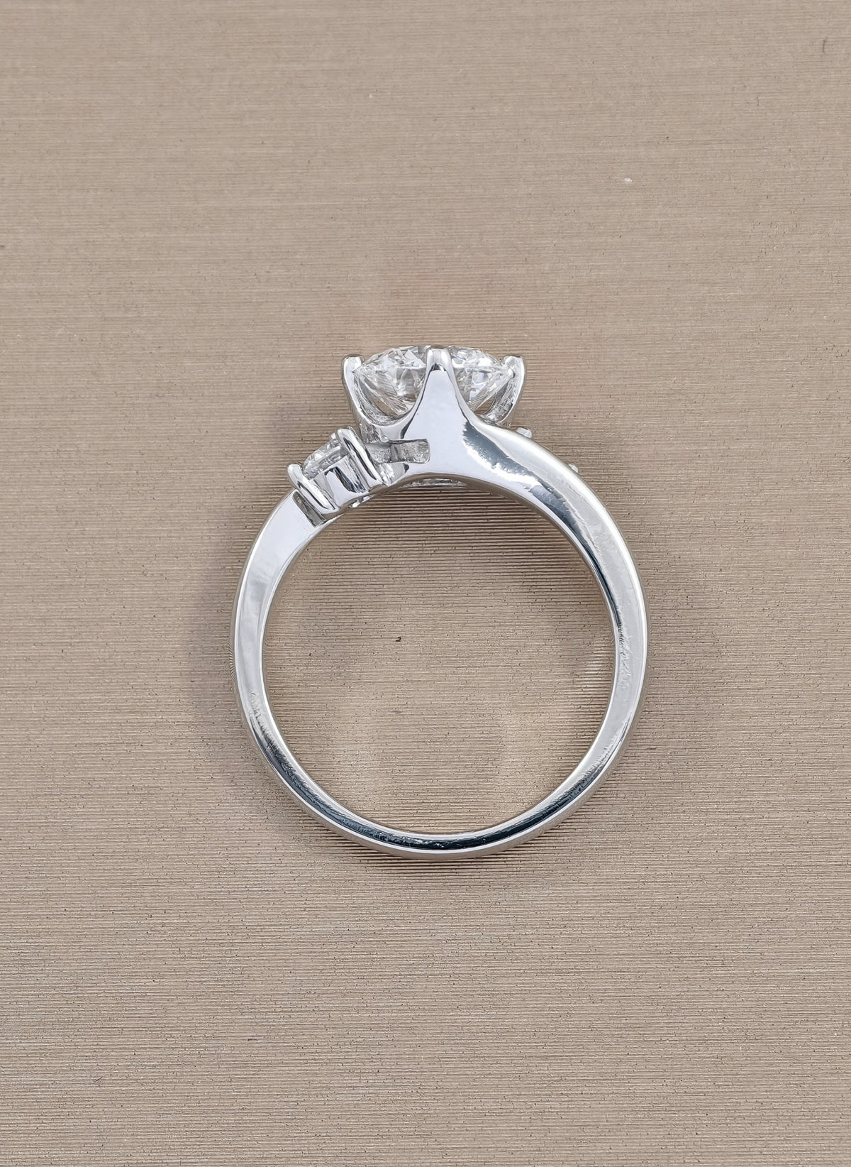 round cut diamond lab grown tree stone engagement ring , four prong  setting white gold, background  color brown 