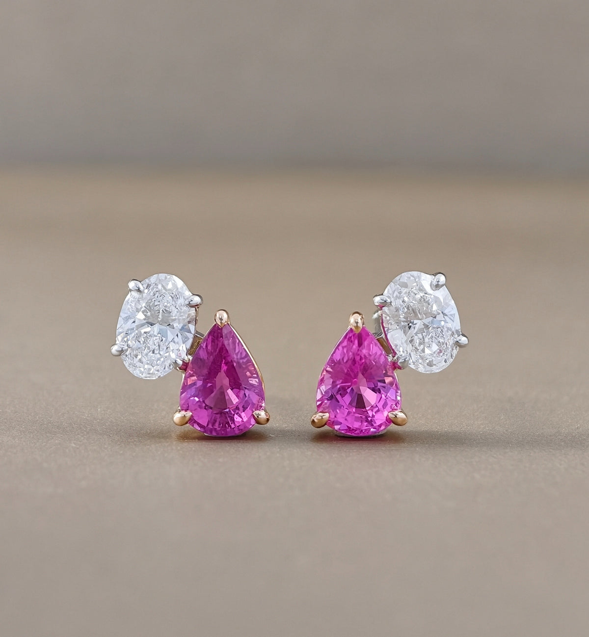 Elegant pink sapphire and oval diamond Toi et Moi stud earrings styled for everyday fine jewelry