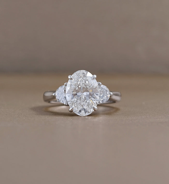 Oval Three-Stone Lab Grown Diamond Engagement Ring with Half-Moon Side Diamonds