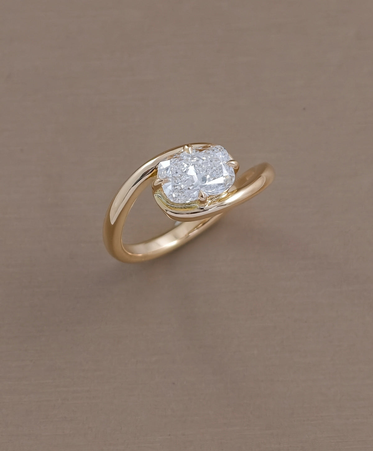 East-West cushion cut lab grown diamond engagement ring with twist yellow gold band by Sphere Diamond