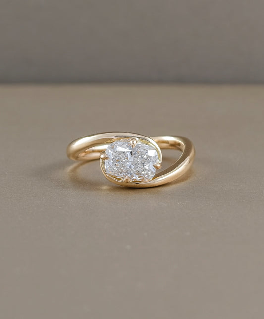 Horizontal cushion solitaire lab grown diamond ring in yellow gold with flowing twist band