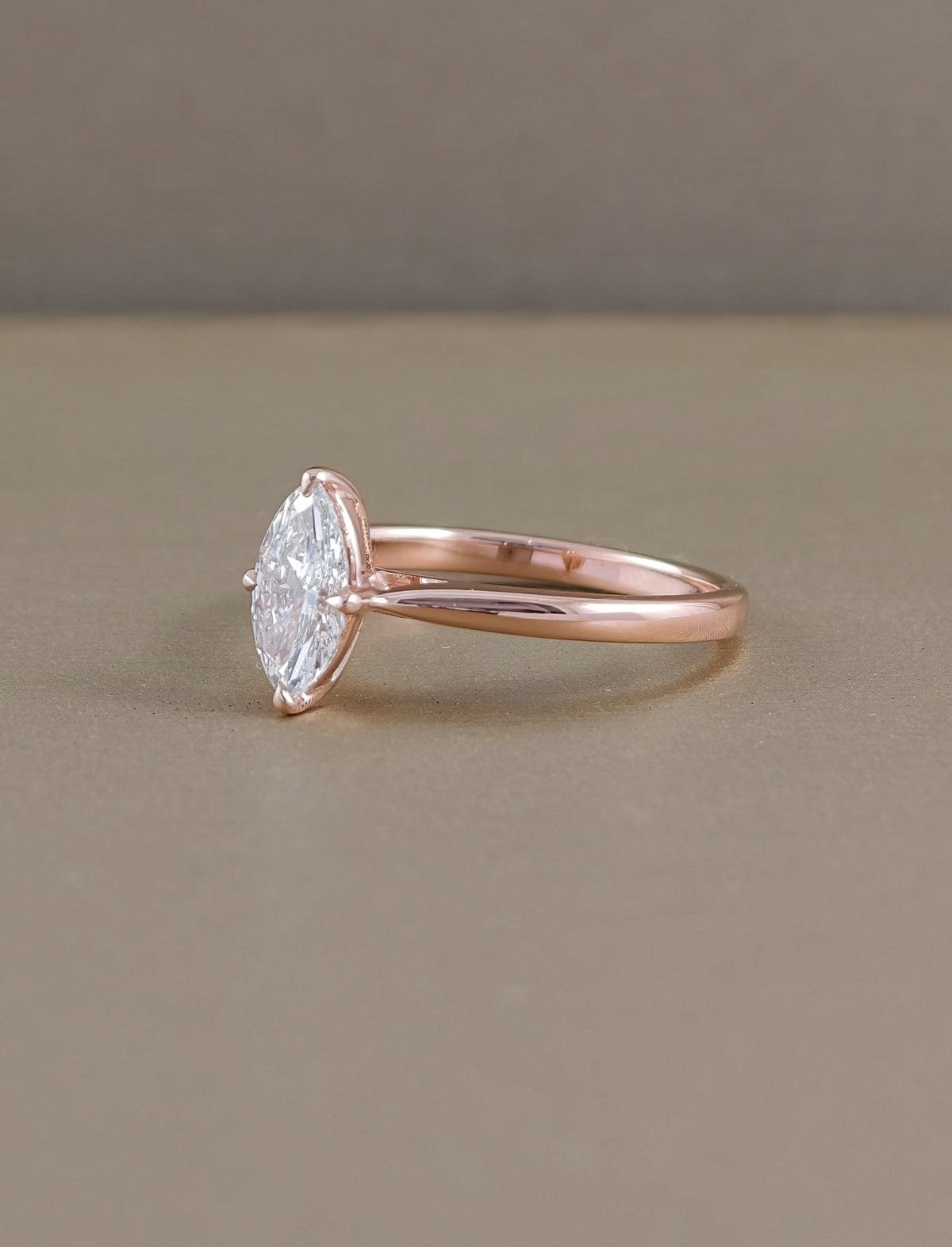Side view of marquise cut lab grown diamond engagement ring with solitaire prong setting in rose gold