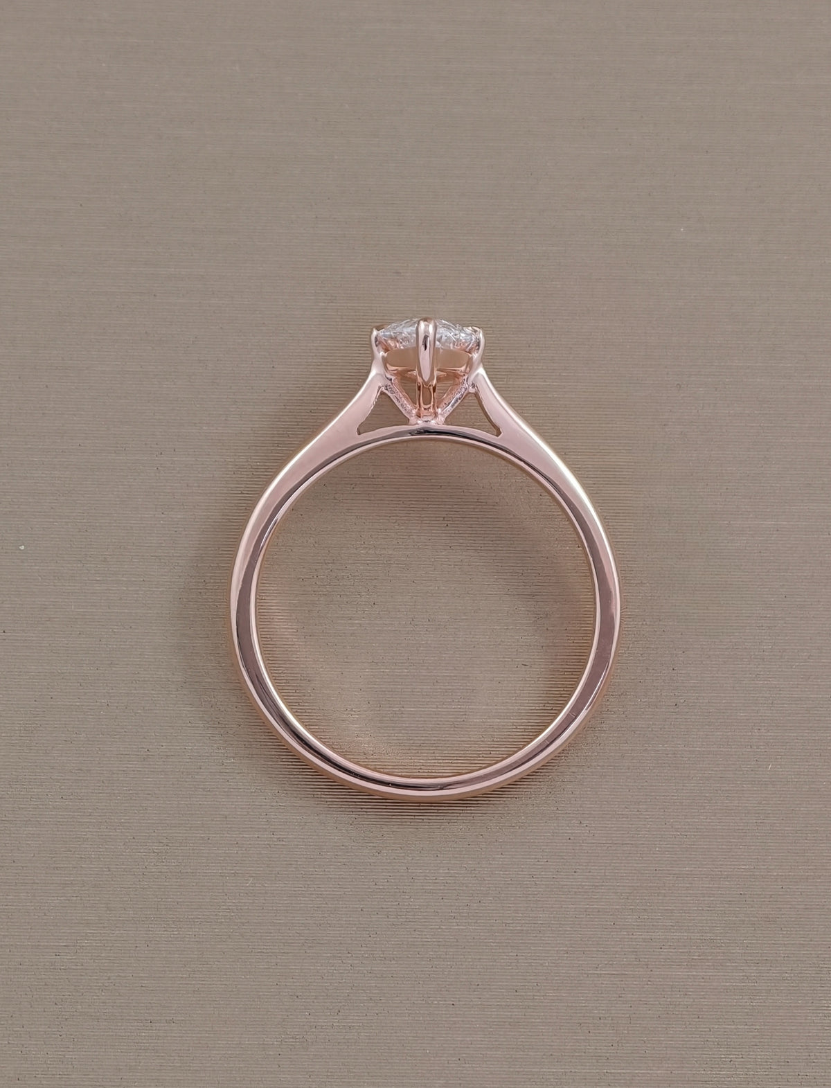 Side view of marquise cut lab grown diamond engagement ring with solitaire prong setting in rose gold