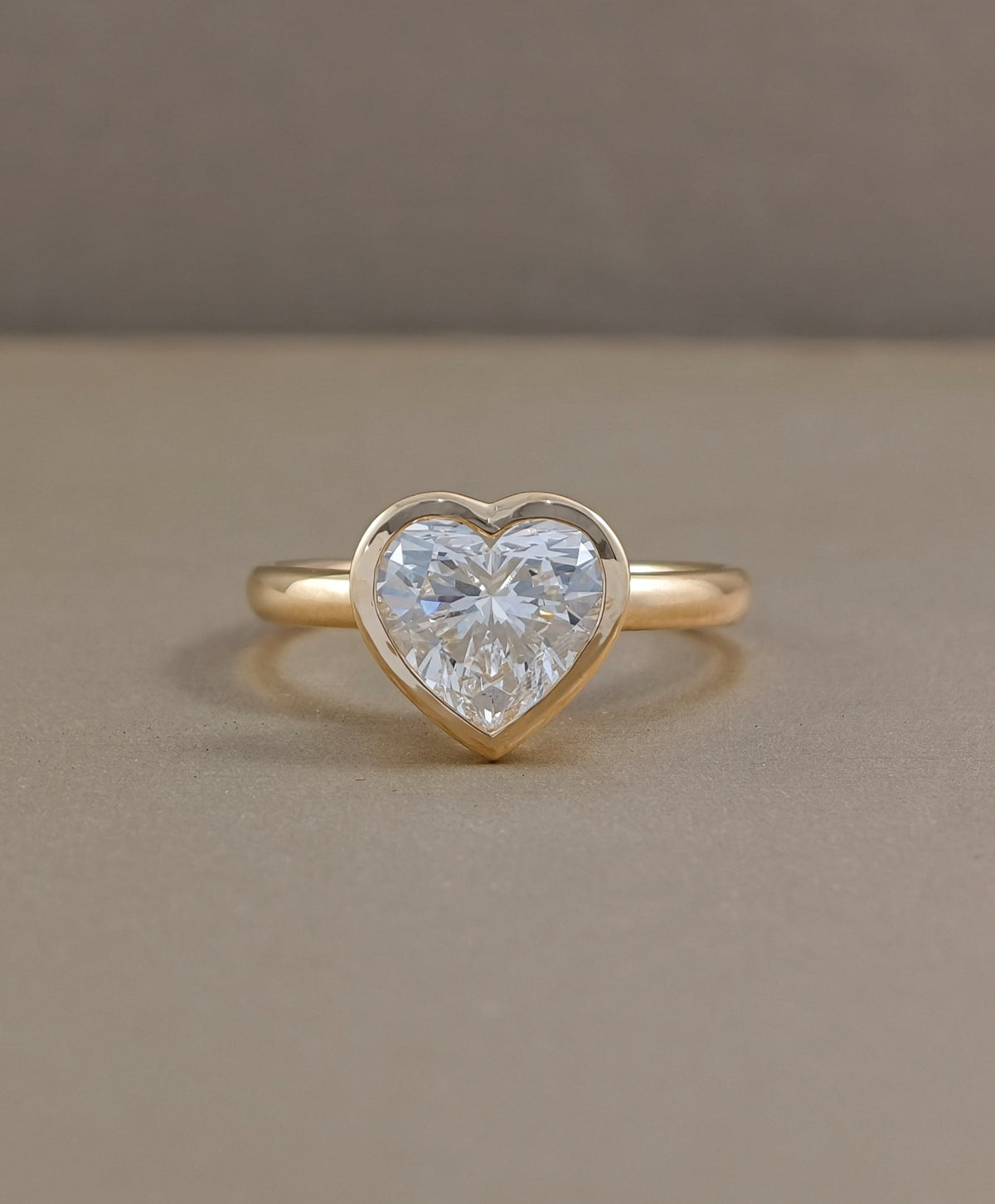 Heart shaped bezel set lab grown diamond engagement ring in yellow gold by Sphere Diamond Bangkok