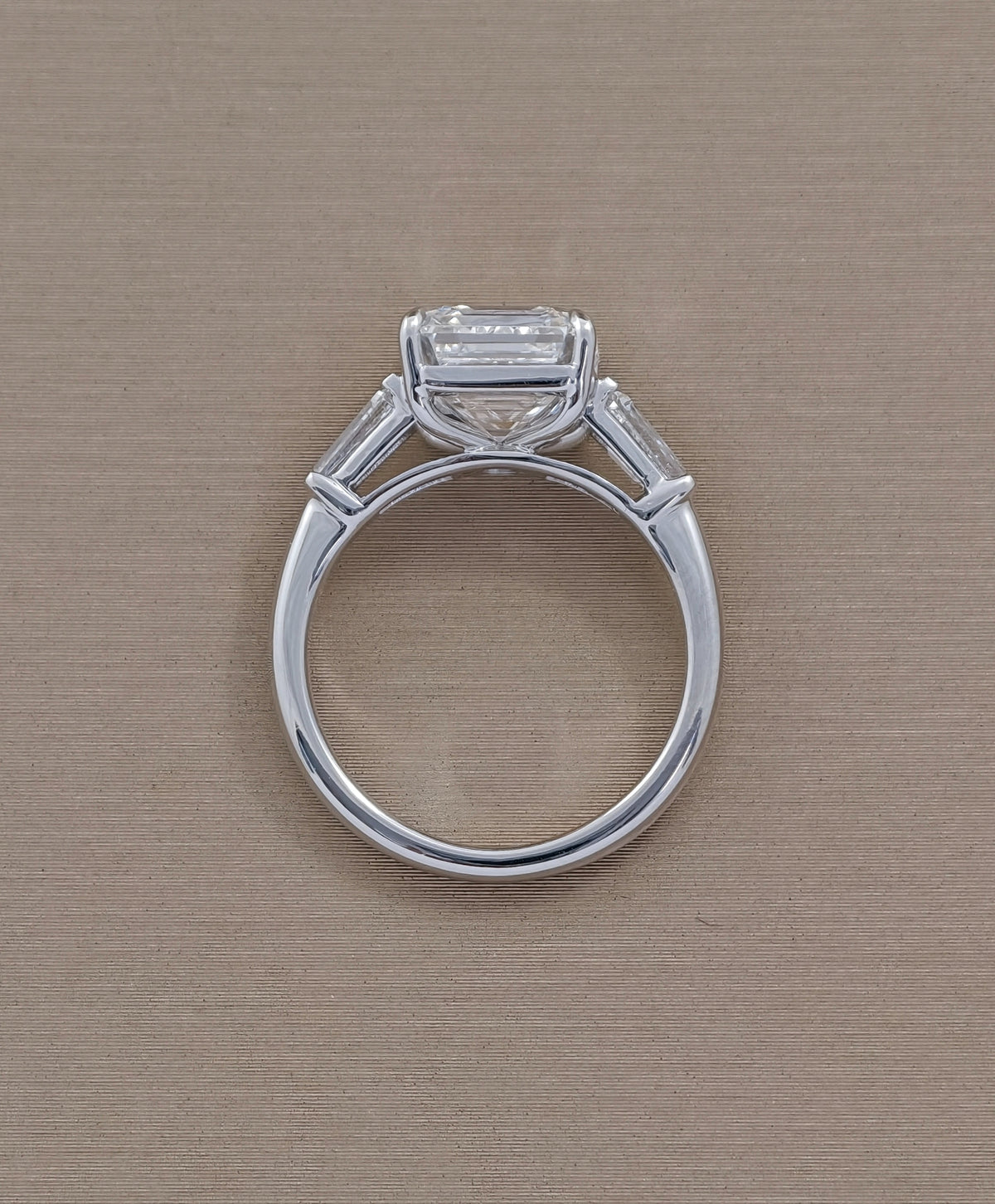Rear view of Asscher three stone lab grown diamond engagement ring showing white gold setting and band