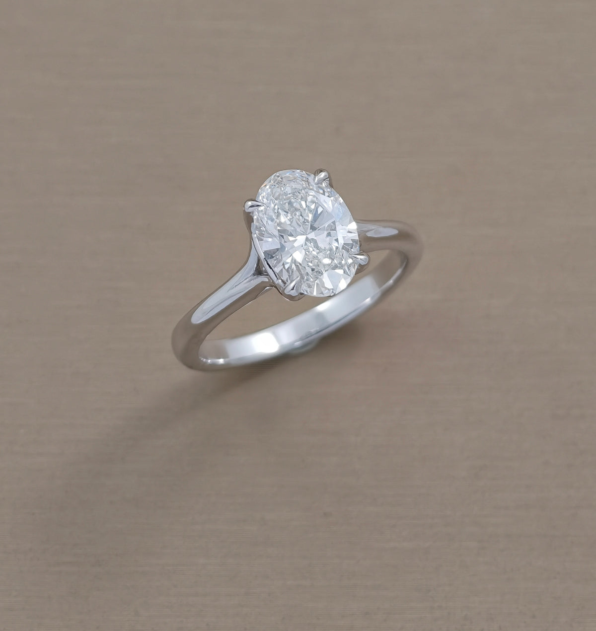 Angled view of Pearry Tulip oval lab grown diamond engagement ring with polished mini split shank