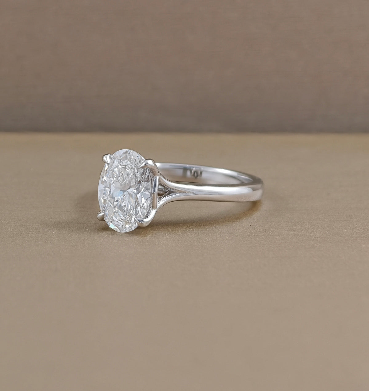 Angled view of Pearry Tulip oval lab grown diamond engagement ring with polished mini split shank