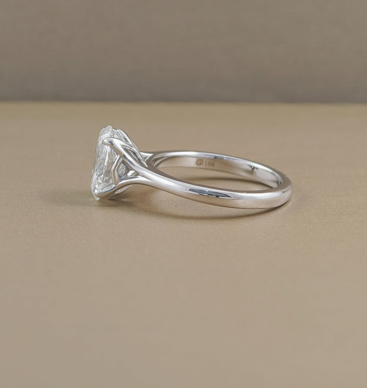 Angled view of Pearry Tulip oval lab grown diamond engagement ring with polished mini split shank