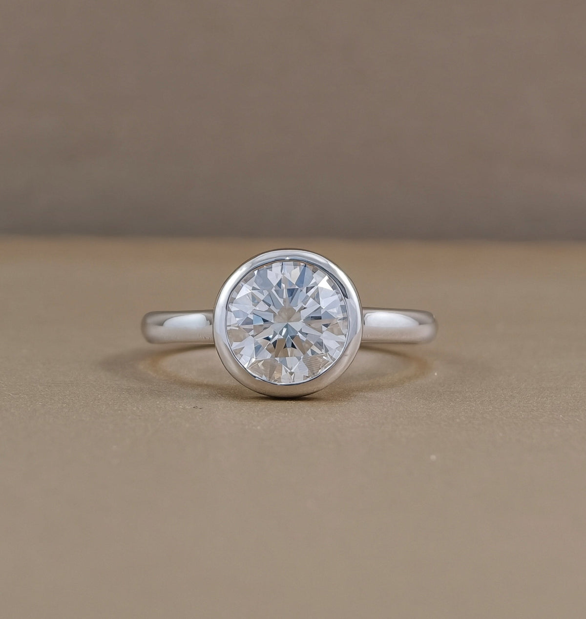 Round bezel set lab grown diamond engagement ring with polished white metal band, Sphere Diamond Bangkok