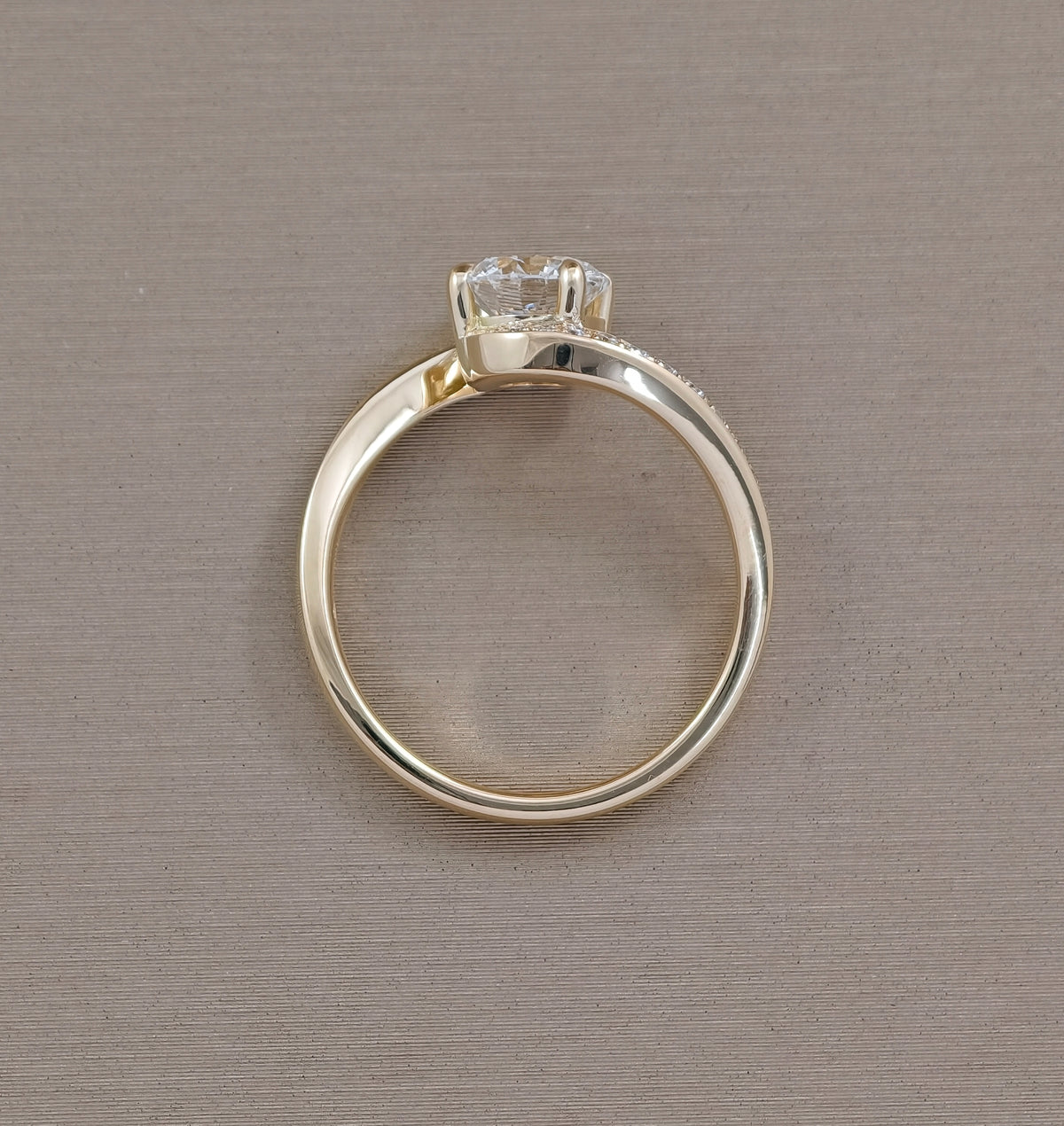 Profile view of Sunset Wave round lab grown diamond engagement ring and yellow gold setting