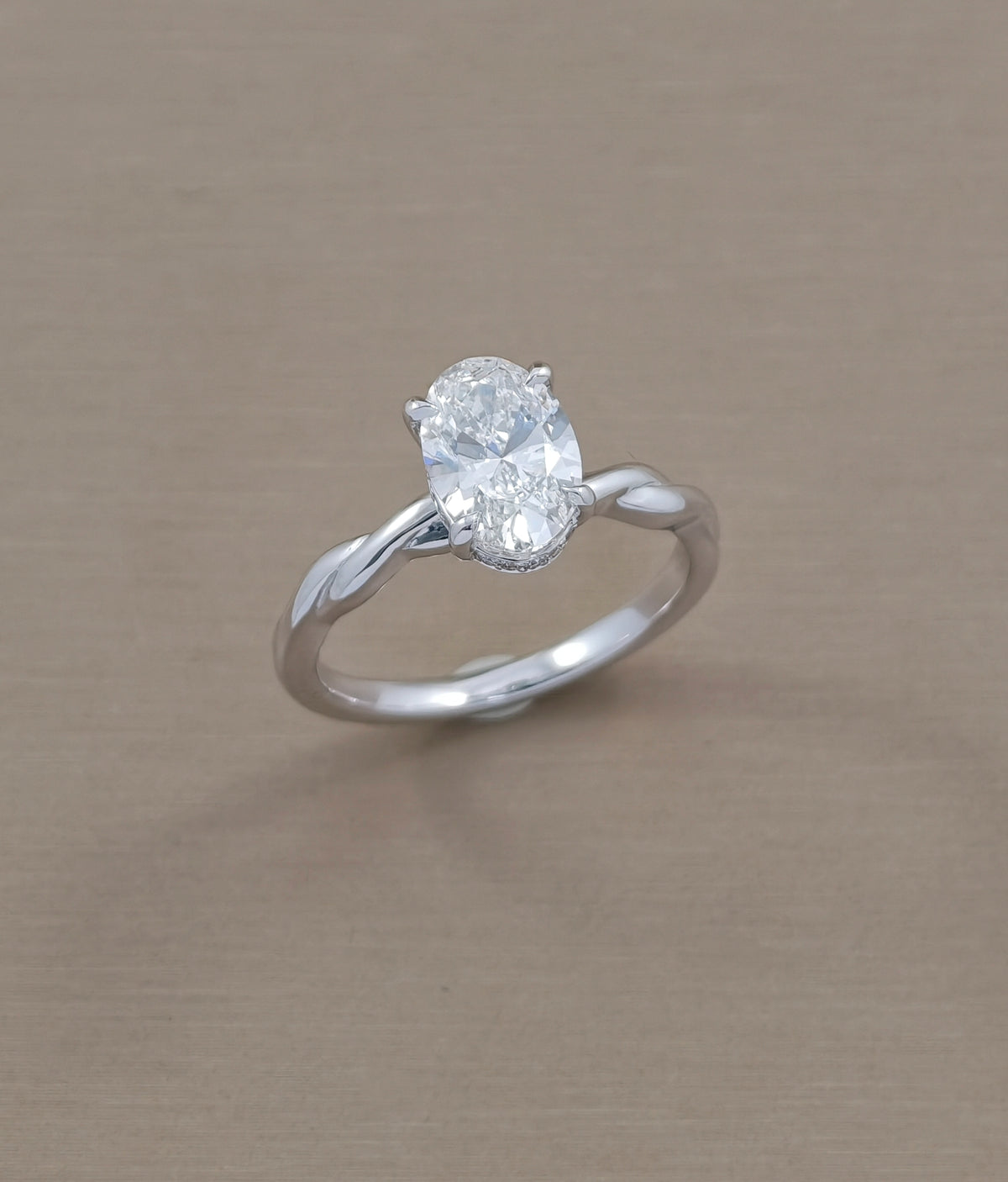 Full profile of oval lab grown diamond engagement ring with infinity inspired twisted shank by Sphere Diamond