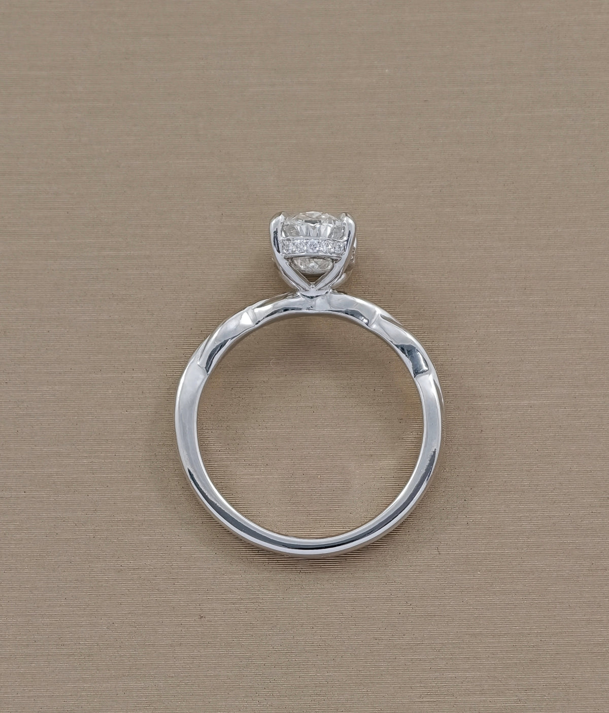 Full profile of oval lab grown diamond engagement ring with infinity inspired twisted shank by Sphere Diamond