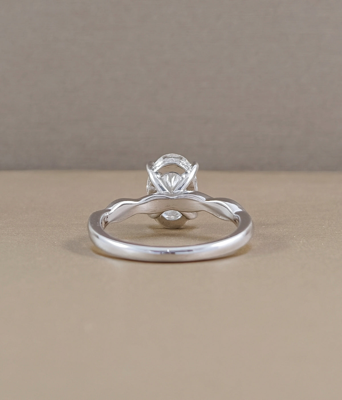 Back view of Infinity Vine oval diamond engagement ring showing white metal band and elevated center diamond setting