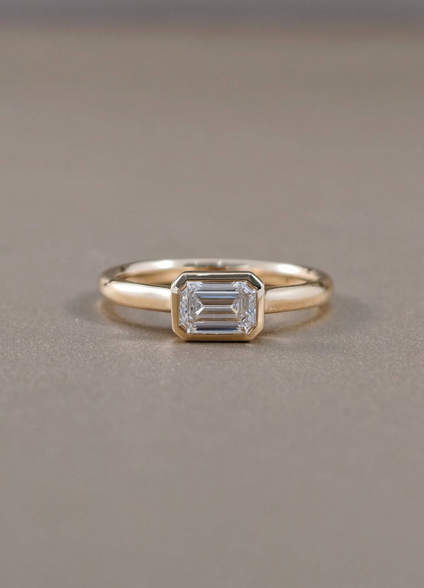 East-West Emerald Cut Lab Grown Diamond Bezel Engagement Ring in Yellow Gold by Sphere Diamond Bangkok