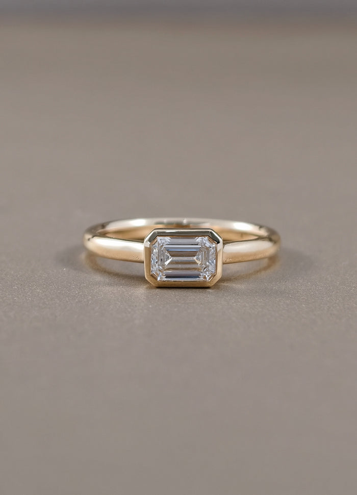 East-West Emerald Cut Lab Grown Diamond Bezel Engagement Ring in Yellow Gold by Sphere Diamond Bangkok