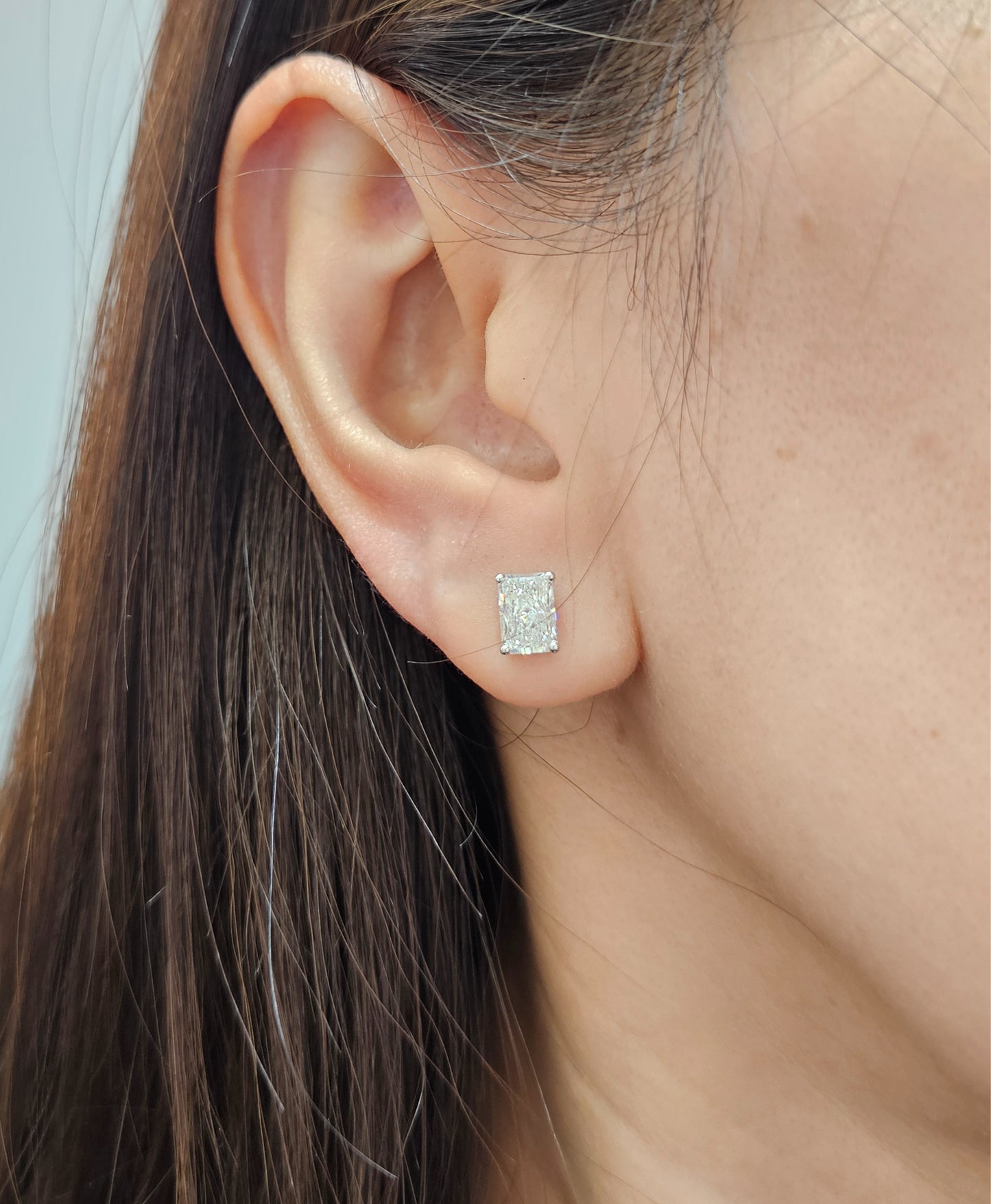 Astra Radiant Lab Grown Diamond Stud Earrings worn on ear featuring IGI Certified diamond by Sphere Diamond Bangkok