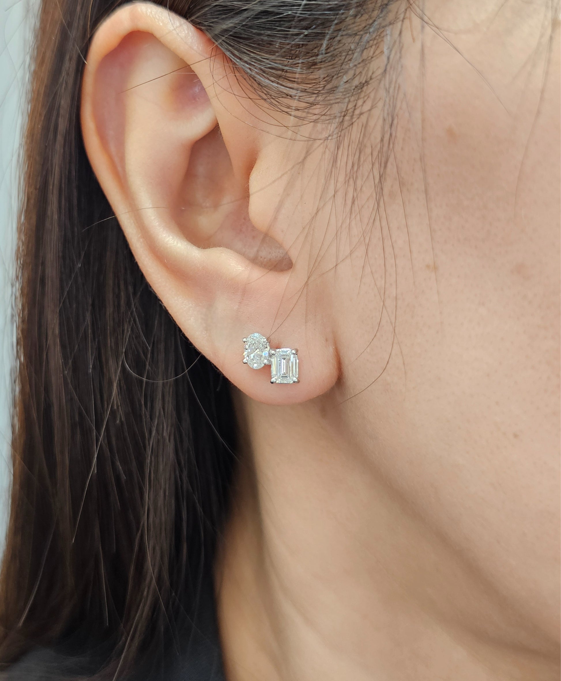 Model wearing Auréa Toi et Moi Oval & Emerald Lab Grown Diamond Stud Earrings with IGI Certified diamonds | Sphere Diamond Bangkok