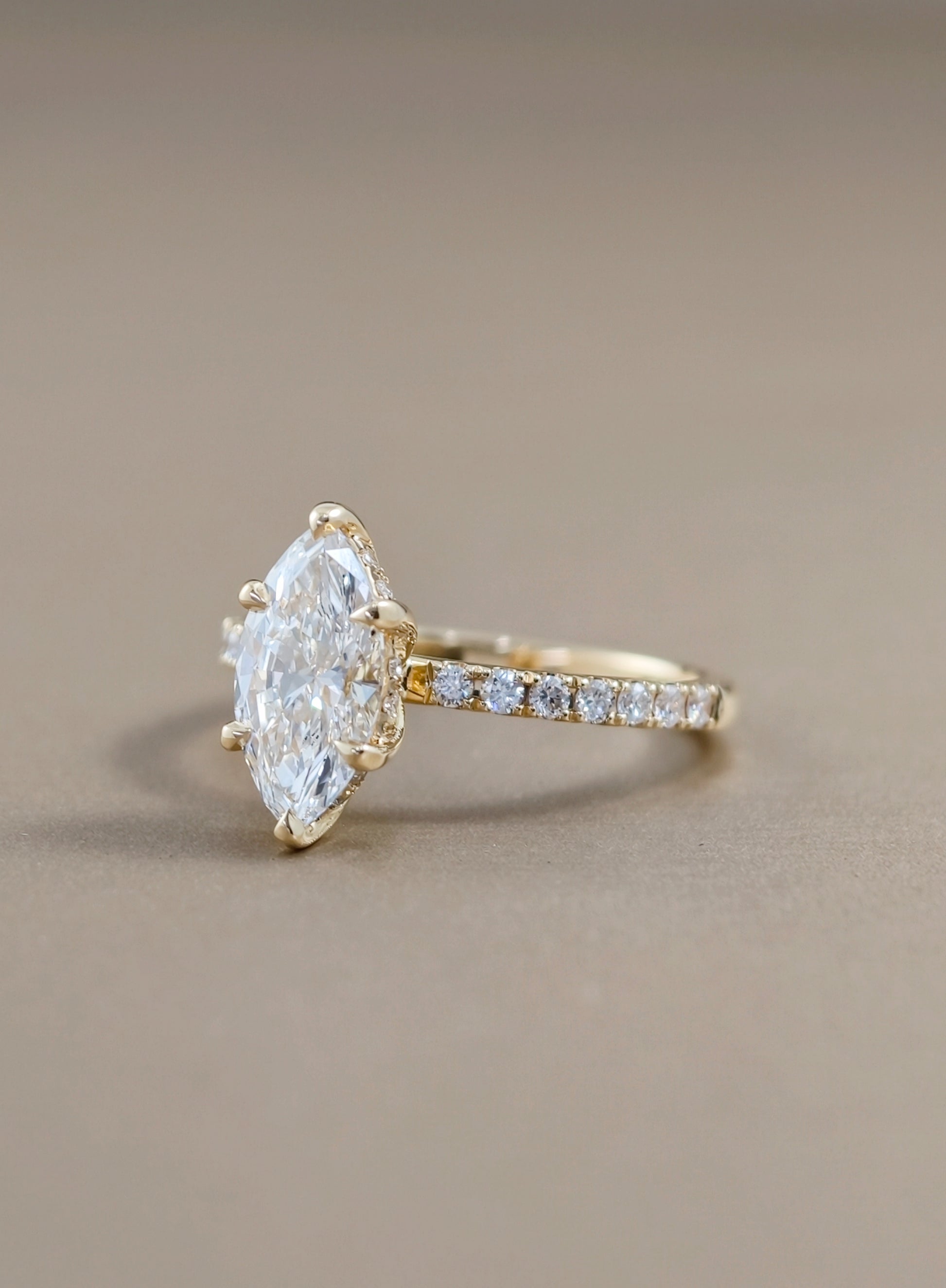 Side view of marquise lab grown diamond engagement ring with pavé band and IGI certified diamond in Bangkok