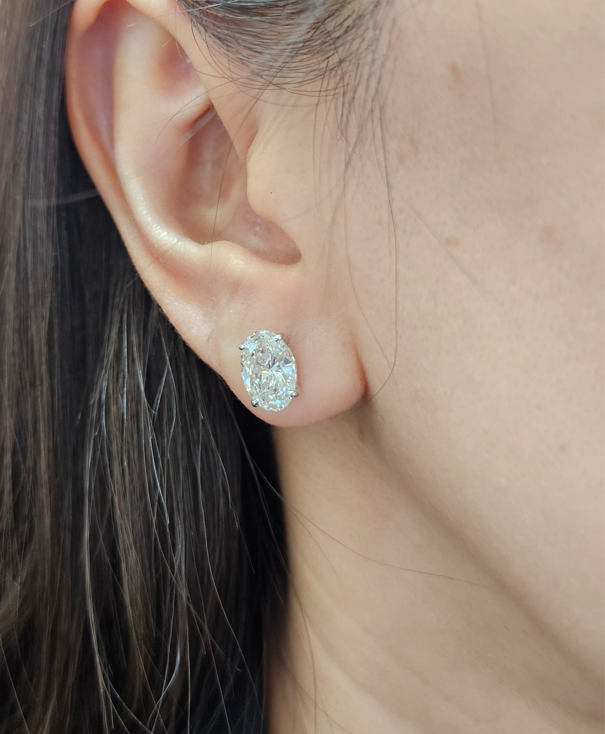 Woman wearing Oval lab grown diamond stud earrings in Bangkok | Sphere Diamond